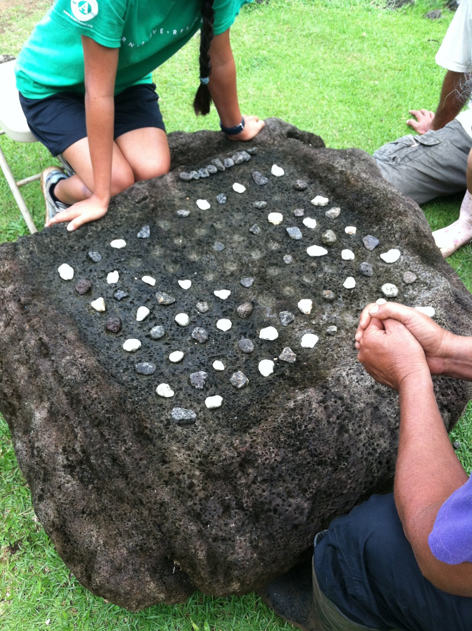 Large rock for playing Konane with two players in a game.
